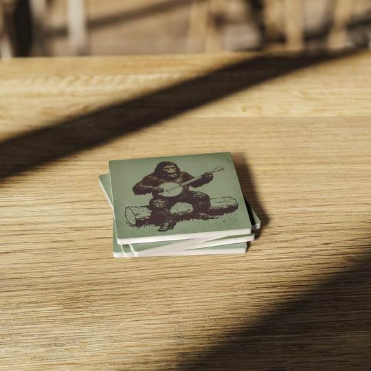 Sasquatch_Banjo_Session_Stone_Coasters__SquareStoneCoaster_WoodTable_AS_Mockup.png
