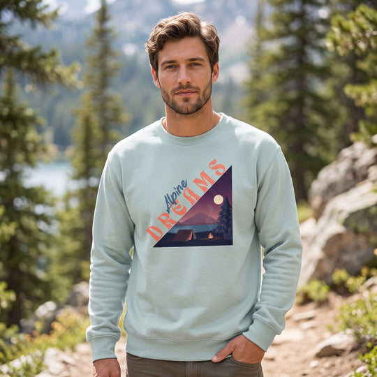 Casual model wearing Alpine Dreams fleece sweatshirt outdoors with natural daylight and greenery in background