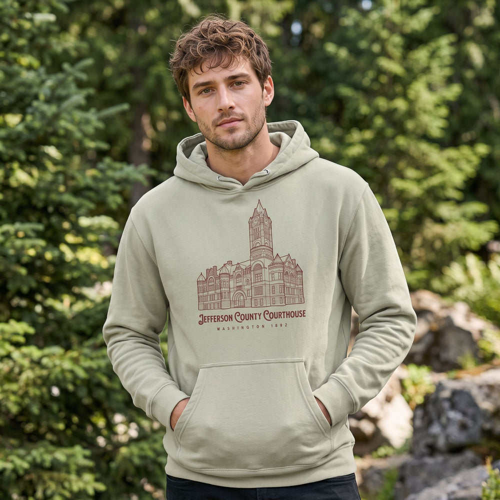 Effortless style of a model wearing Jefferson County Courthouse hoodie outdoors in bright sunlight with organic background elements.