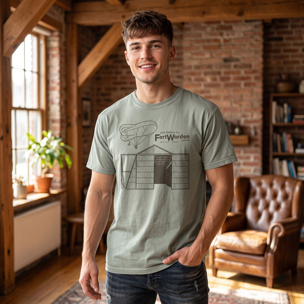 Model in casual modern style wearing the heavyweight t-shirt in a warm, inviting living room.