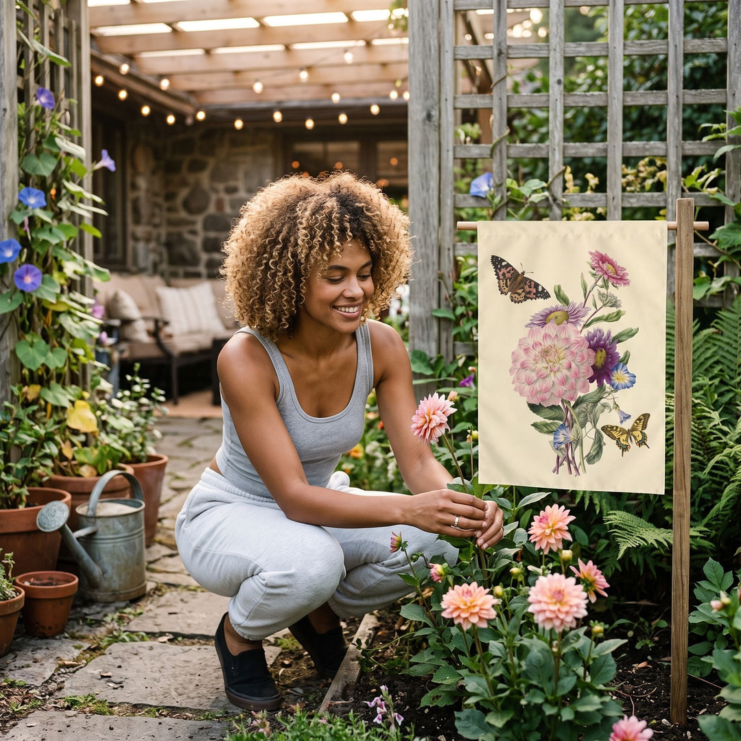 Relaxed indoor setting featuring the Victorian Dahlia Garden Flag on a wall, with a woman enjoying the botanical artwork in a cozy atmosphere