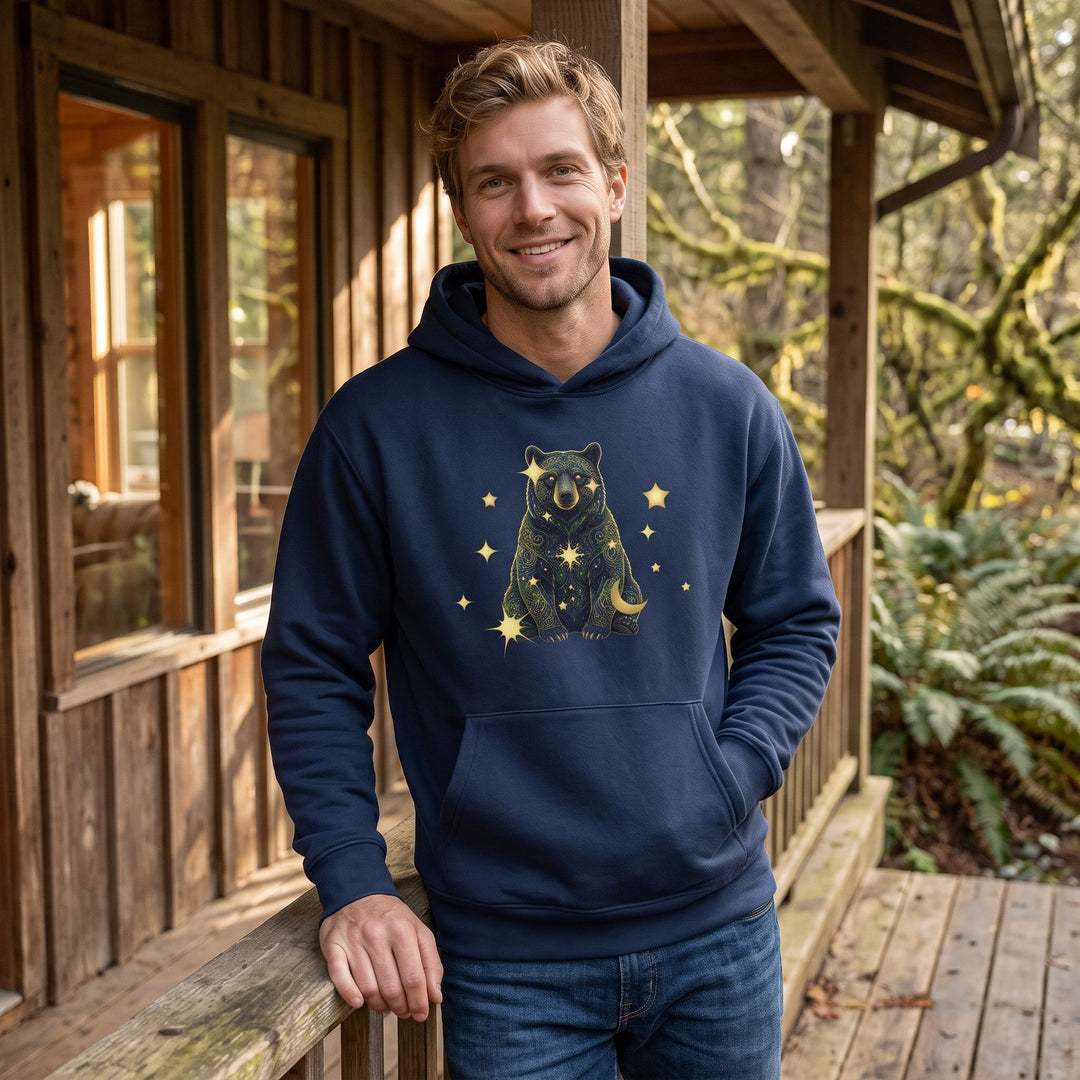 Adult male model wearing Virgo Black Bear organic fleece hoodie in a cozy living room setting.