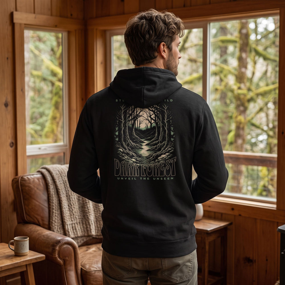 Casual man wearing dark forest fleece hoodie in cozy, natural indoor setting with warm natural lighting.