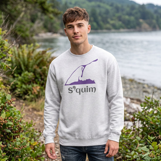 Young adult male model wearing The Dungeness Spit Fleece Crew sweater outdoors with greenery and water in the background