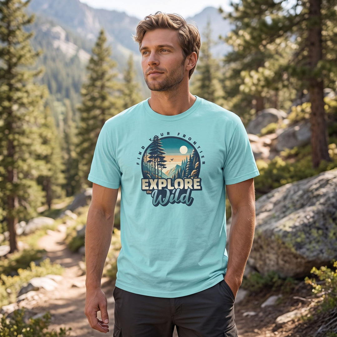 Outdoor mountain scene T-shirt featuring wilderness design with inspiring quotes for adventurers, modeled in natural daylight setting.