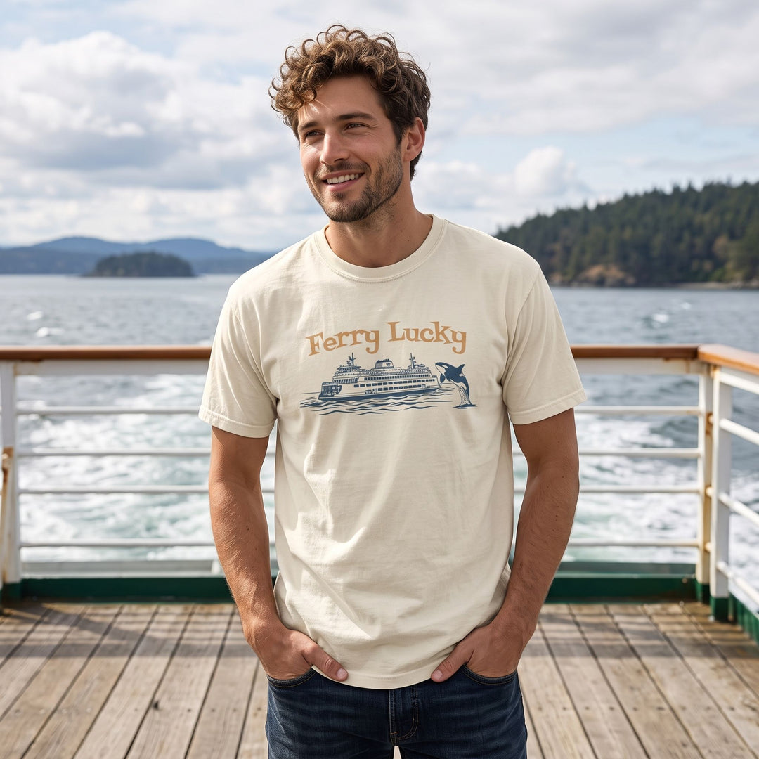 Model wearing the Ferry Lucky graphic T-shirt in a natural outdoor environment with foliage, highlighting its vintage, relaxed maritime style.