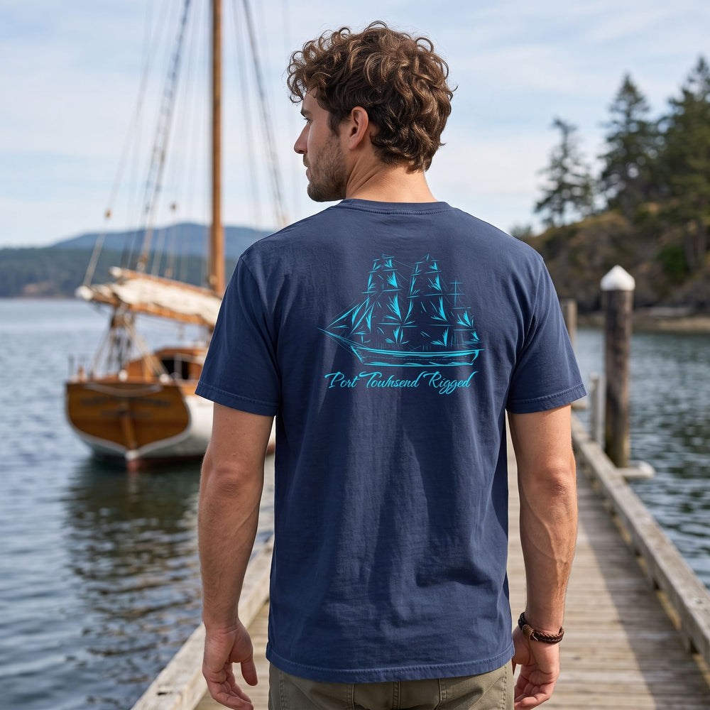 Relaxed male model in Port Townsend heavyweight t-shirt in outdoor natural setting with foliage and water.
