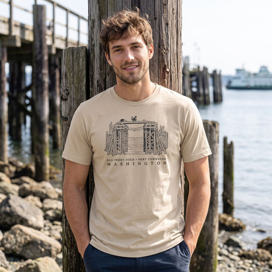 Casual model wearing the Old Ferry Dock Organic Tee outdoors, emphasizing the heritage dock illustration amidst natural surroundings.