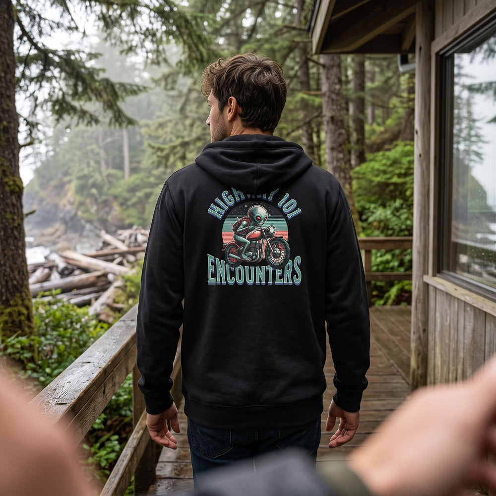 Casual scene featuring Alex wearing Highway 101 Encounters Zip Hoodie in a cozy living room with warm natural light.