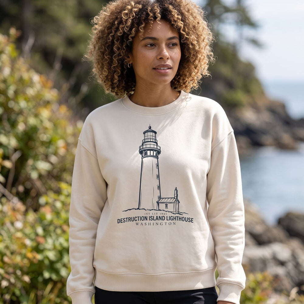 Casual adult model in outdoor setting showcasing lighthouse-themed crew neck sweatshirt amid nature scene.
