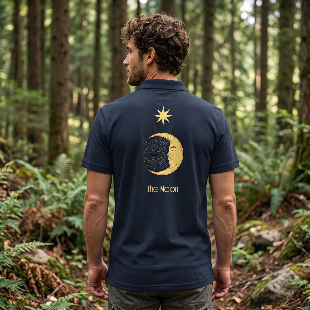 Men's tarot the moon polo in grey melange worn outdoors with greenery in background, highlighting relaxed style and subtle mystic design.
