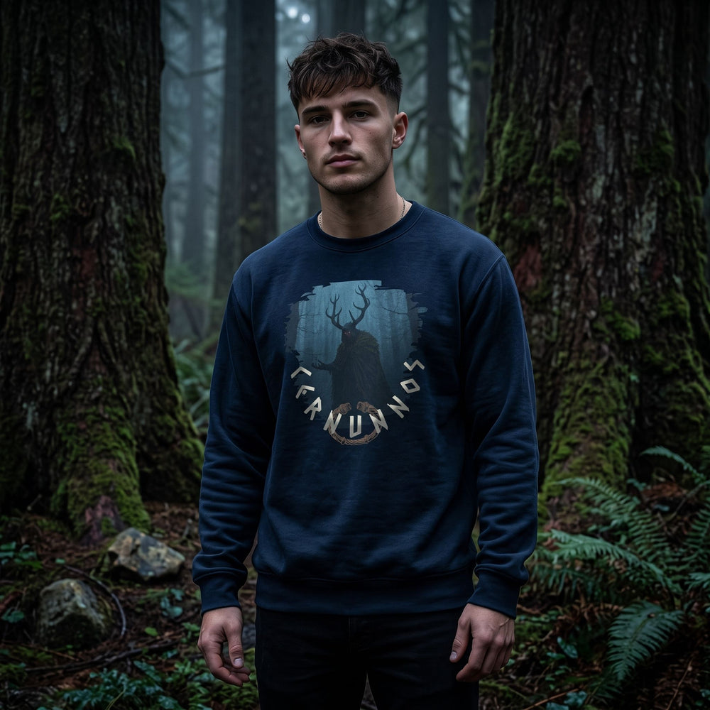 Model wearing Cernunnos crewneck sweatshirt in deep shadows and rich textures setting with dark woods.