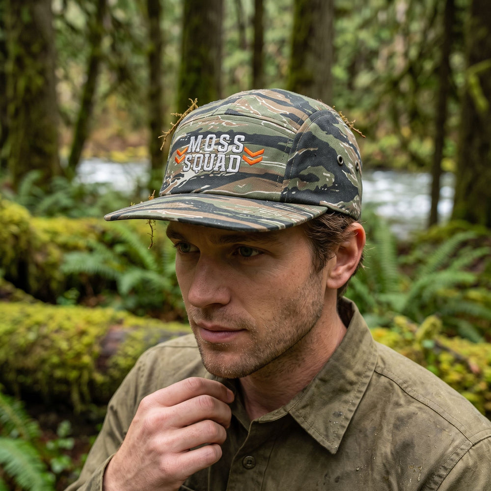 Camouflage camper cap with green tiger pattern, suitable for outdoor camping and nature exploration.