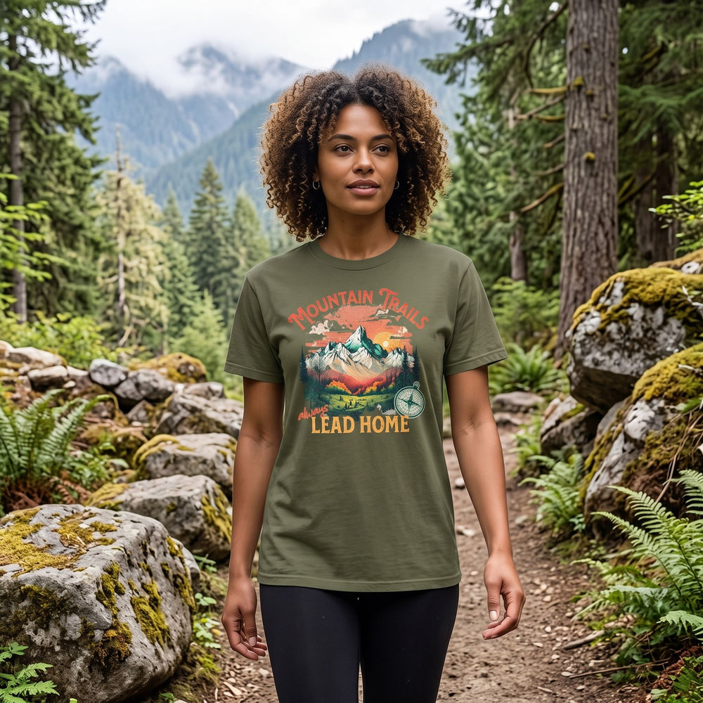 Model wearing Mountain Trails Garment-Dyed Tee in outdoor setting with greenery, showcasing the relaxed fit and mountain forest design.