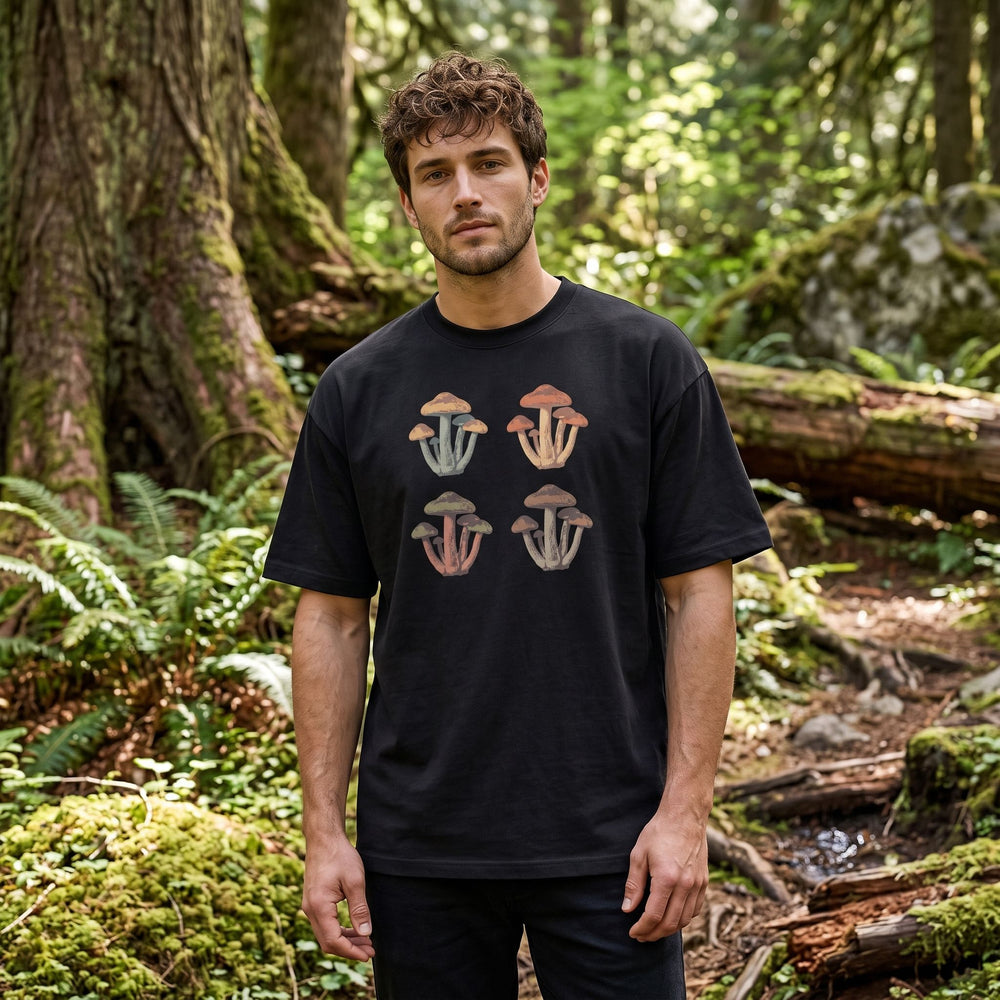 Adult model wearing heavy-duty white tee with mushroom graphic in outdoor natural setting