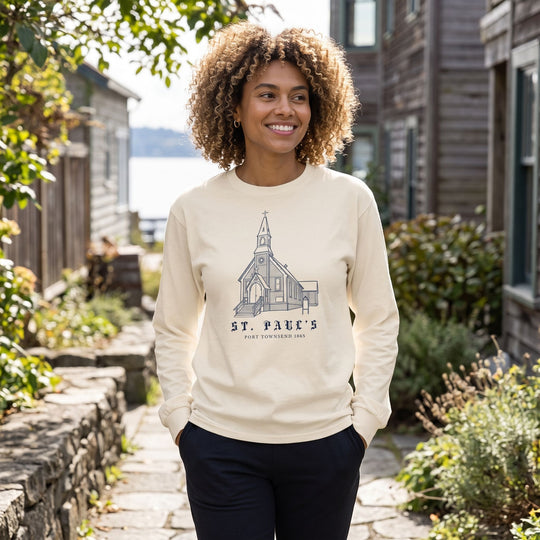 Adult model outdoors in natural light wearing the historic long sleeve shirt, emphasizing the premium cotton fabric and bold lettering.