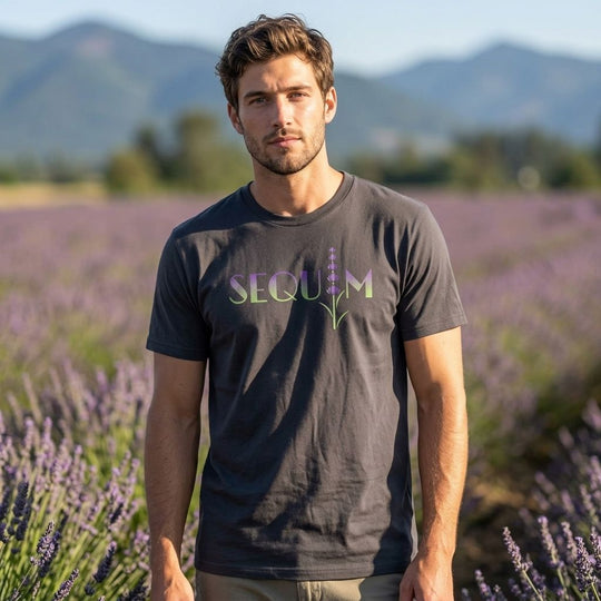 Casual model wearing the lavender-themed organic cotton T-shirt in an outdoor setting with blurred foliage and natural light.