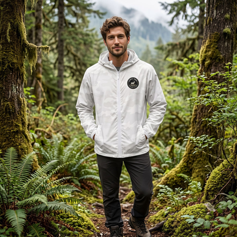 Model wearing Olympic Forest Windbreaker outdoors among greenery, showcasing its water-resistant and windproof features.