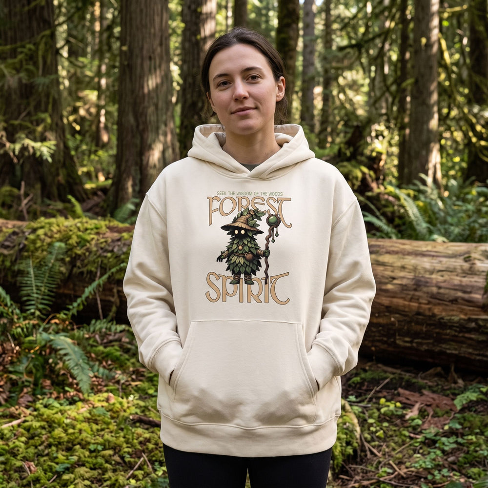 Model wearing Forest Spirit Oversized Hoodie in a lush outdoor forest setting with dappled sunlight.