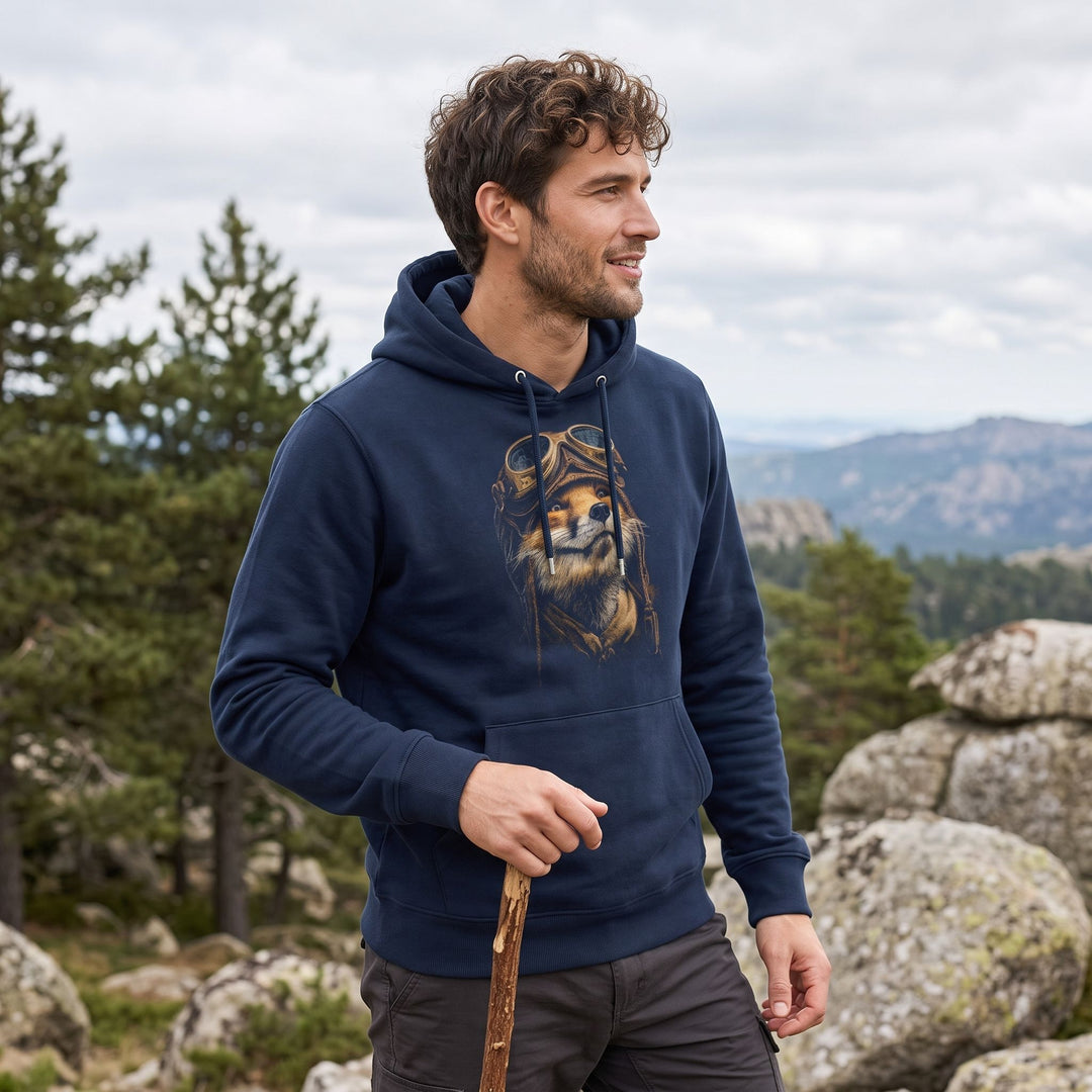 Model wearing The High-Altitude Ace hoodie outdoors amidst greenery, showcasing its relaxed fit and vintage design with natural lighting.