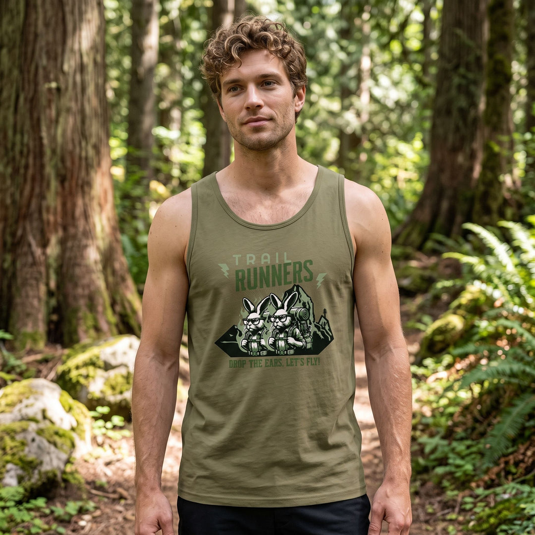 Model Ben wearing The Jackrabbit Velocity Premium Tank in an outdoor setting with greenery, showcasing a relaxed fit and breathable design for trail running.