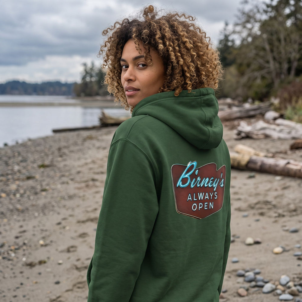 Model wearing Birney's Always Open Hoodie outdoors with greenery in the background, showcasing its casual, outdoor style and natural setting.