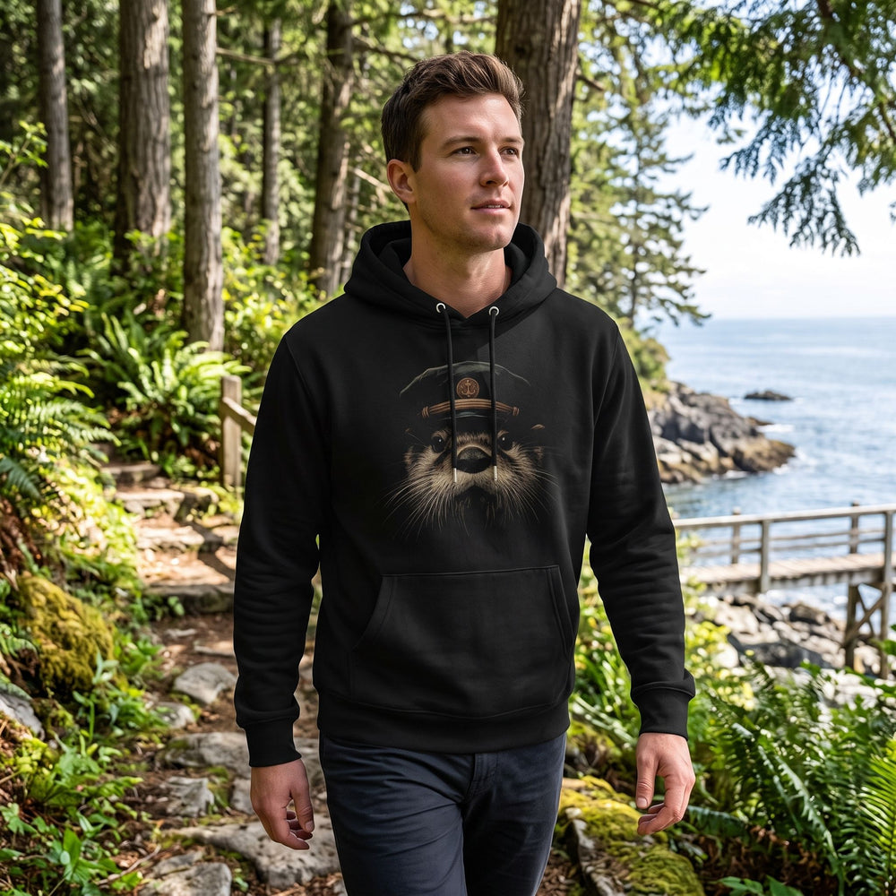 Olive green heavyweight hoodie from the Olympic Crew displayed on a wooden dock with lush greenery and sky in the background.