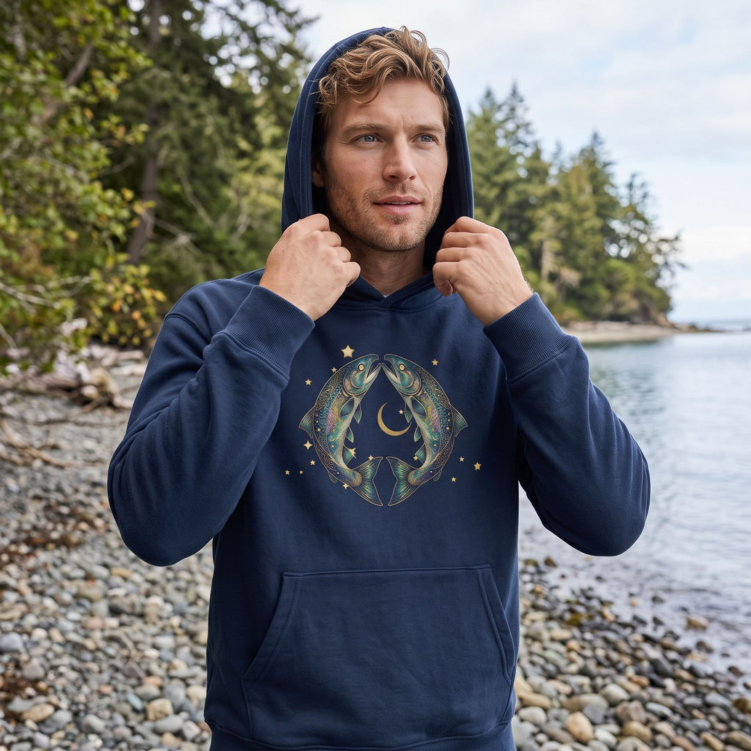 Model Ben wearing organic fleece hoodie in outdoor nature setting with greenery and blurred foliage