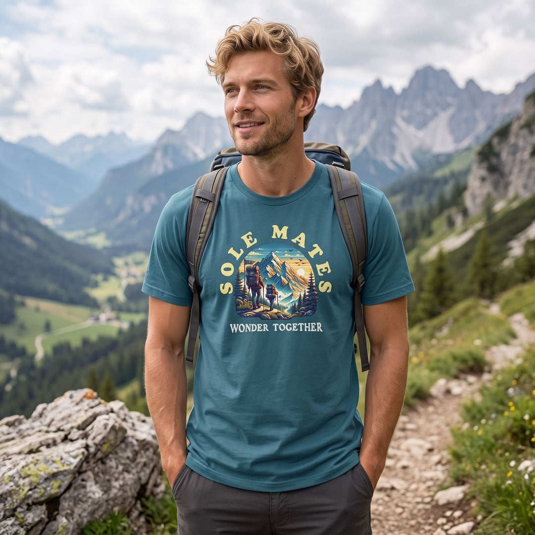 Model wearing the organic cotton Sole Mates Wonder Tee outdoors against blurred foliage with bright sunlight, showcasing casual style and natural setting.