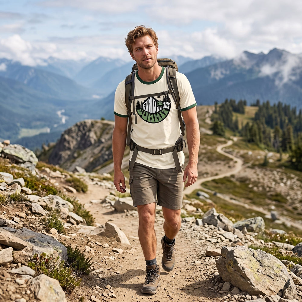 Male model wearing The Summit Signal Ringer Tee in an outdoor setting with greenery and natural daylight, surrounded by blurred foliage and rocks.