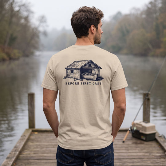Casual organic tee featuring a woodcut-style skiff graphic worn outdoors with greenery in background