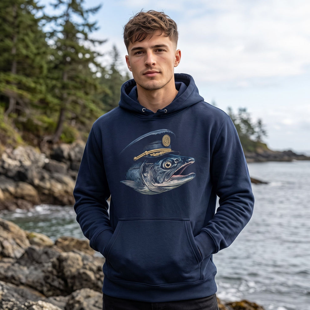 Young man wearing the navy blue marine crew hoodie outdoors with greenery in the background, showcasing a casual style and relaxed fit.