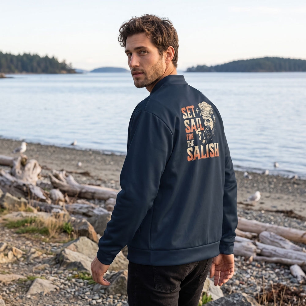Casual male model wearing the Port Townsend Bomber Jacket outdoors with greenery and water in the background, capturing relaxed, adventurous style.