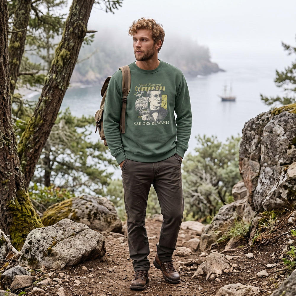 Model wearing Port Townsend Crimper King sweatshirt outdoors with natural greenery and bright sunlight.