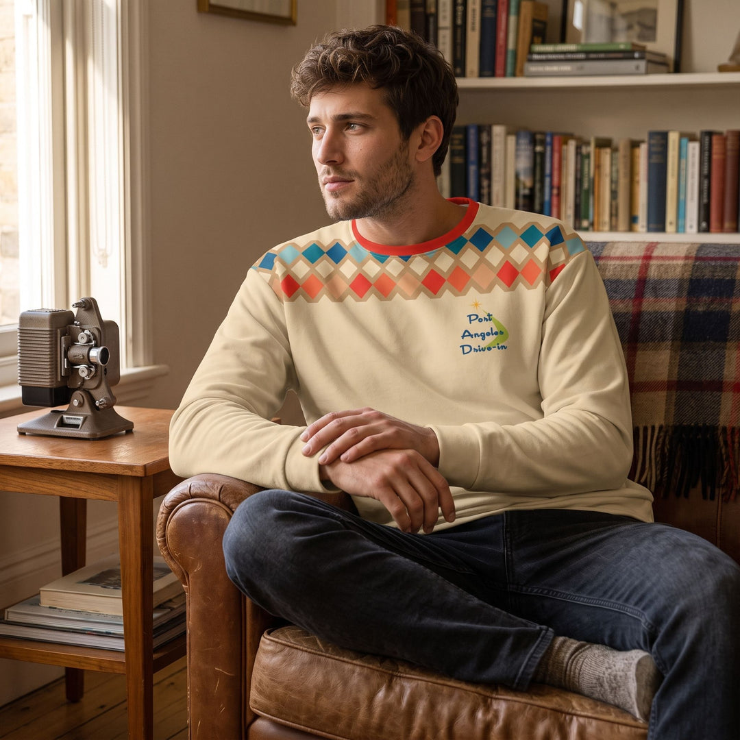 Casual man wearing retro Port Angeles sweatshirt in cozy living room with warm natural light, embracing a nostalgic, inviting atmosphere.