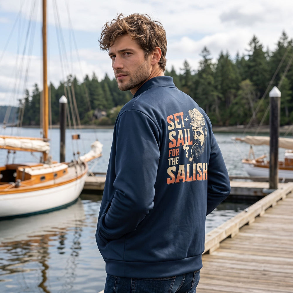Stylish bomber jacket featuring a Salish Sea inspired design, worn by a model in a relaxed outdoor environment.