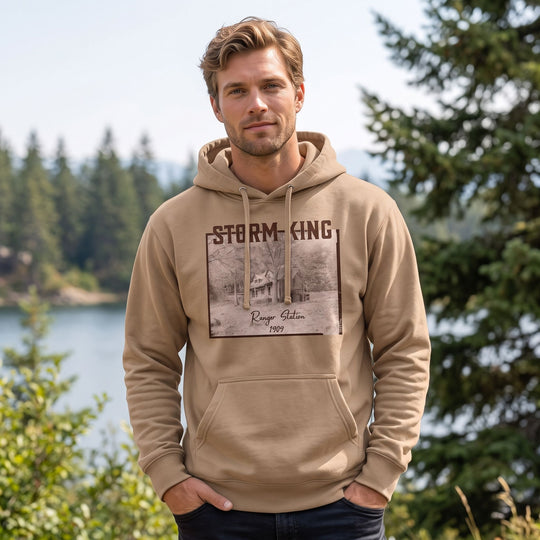 Model in outdoor scenery wearing the warm heavyweight Storm King Ranger Station hoodie, emphasizing rugged outdoor style.