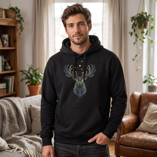 Casual man wearing Sagittarius Roosevelt Elk fleece hoodie in cozy living room with warm natural lighting.