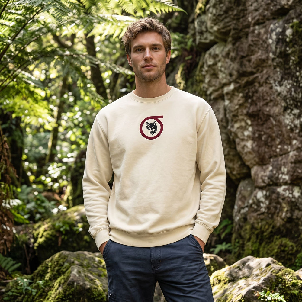 Adult male model wearing Sigma Wolf embroidered fleece in outdoor setting with greenery and natural daylight.