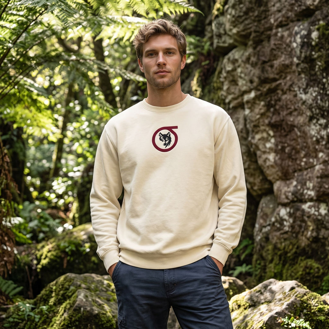 Adult male model wearing Sigma Wolf embroidered fleece in outdoor setting with greenery and natural daylight.