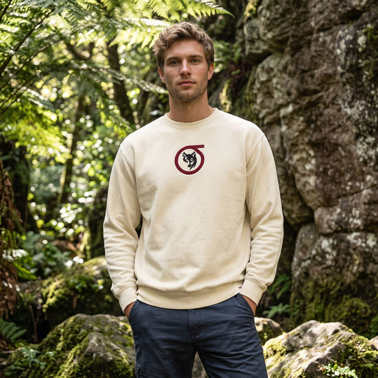 Adult male model wearing Sigma Wolf embroidered fleece in outdoor setting with greenery and natural daylight.