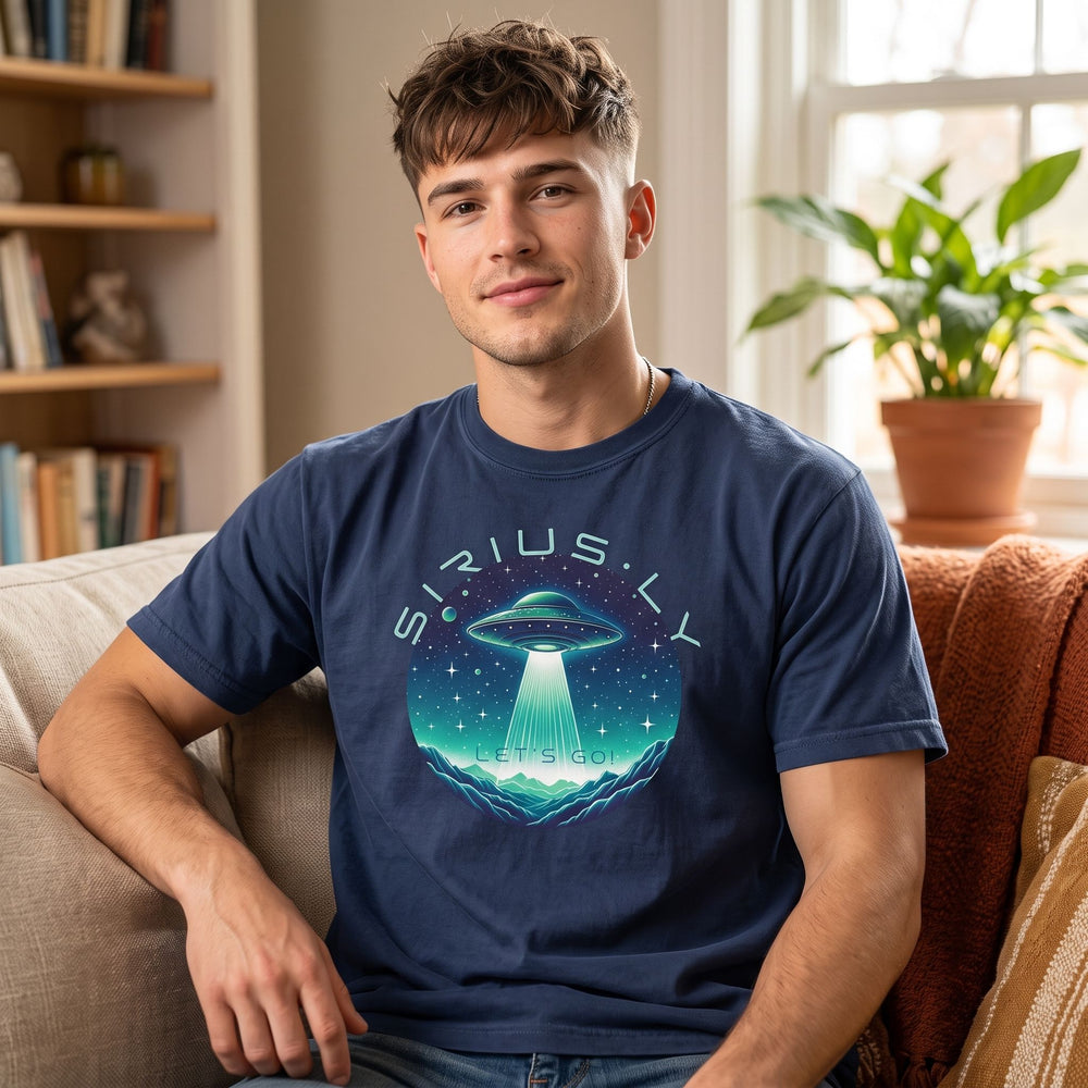 Young adult male model wearing Sirius-ly Let's Go T-shirt in cozy home setting, soft warm natural light highlights the vibrant sci-fi illustration.