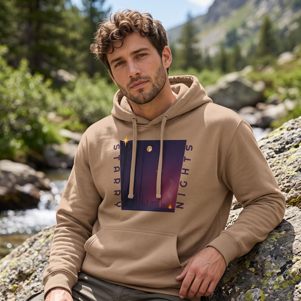 Casual adult model wearing Starry Nights hoodie outdoors in natural daylight, surrounded by greenery and nature elements.