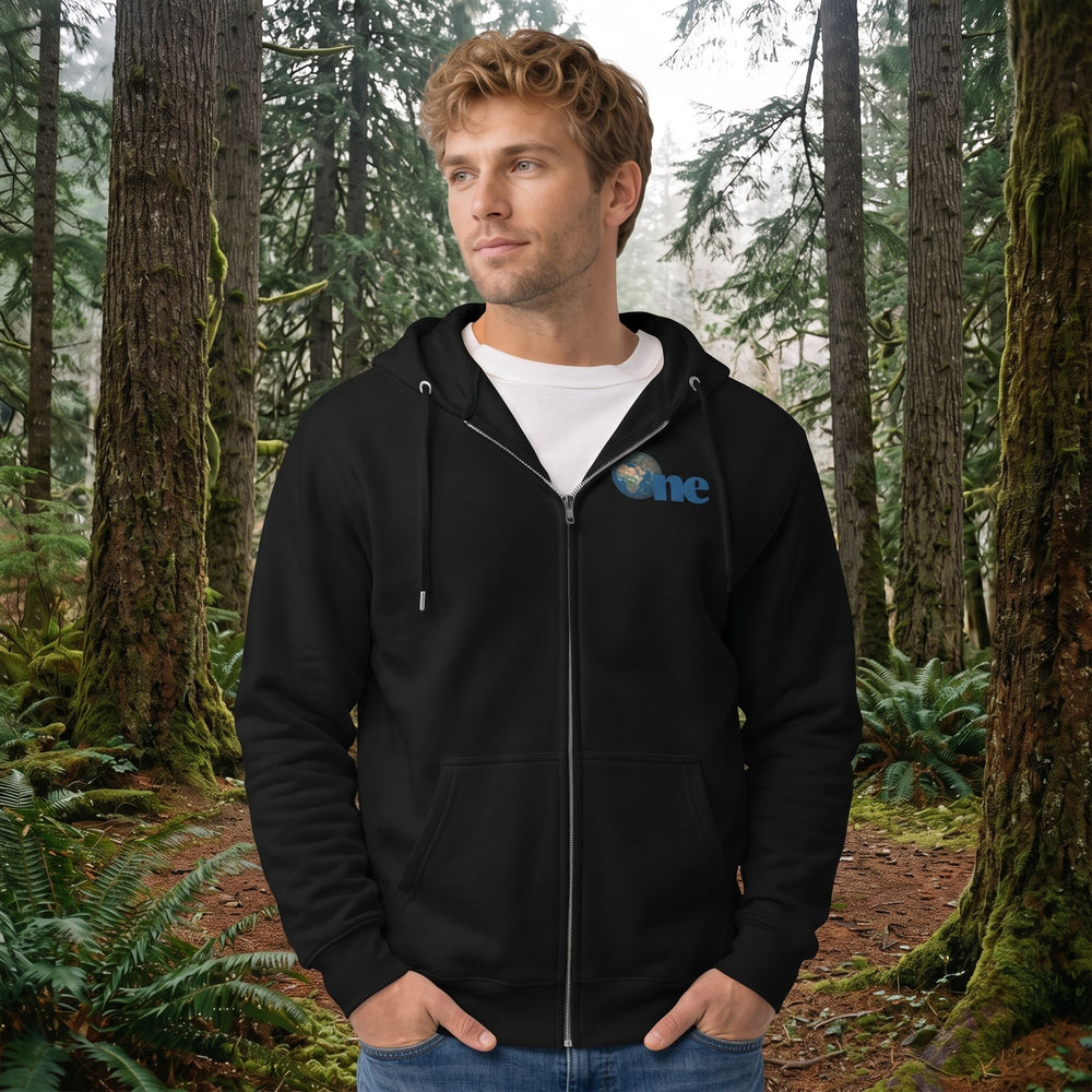 Adult model wearing The 'One Earth' Premium Zip Hoodie outdoors with greenery in the background, showcasing a global Earth graphic design.