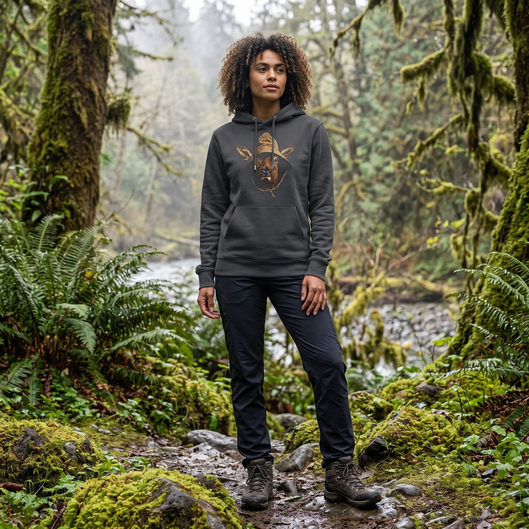 Outdoor scene with Zara modeling The Rainforest Regular heavyweight hoodie in natural daylight, surrounded by greenery and blurred foliage.