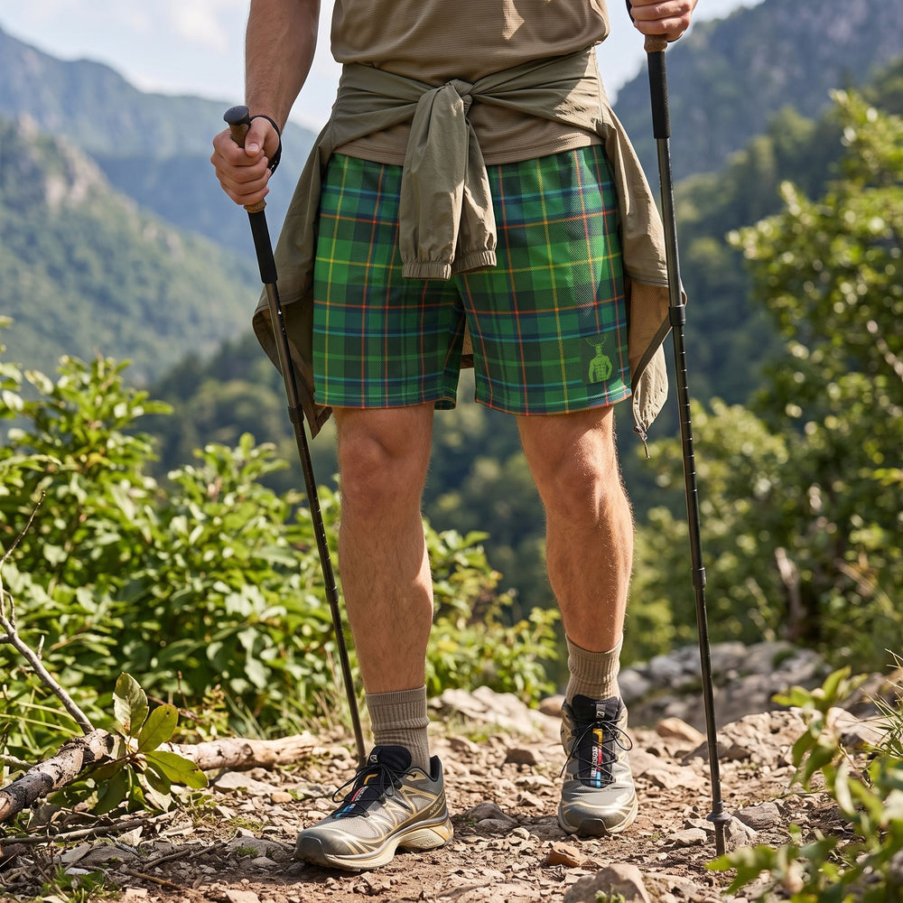 Relaxed adult model wearing Untamed Tartan Mesh Cernunnos Shorts in outdoor setting with greenery, perfect for adventure and casual wear.