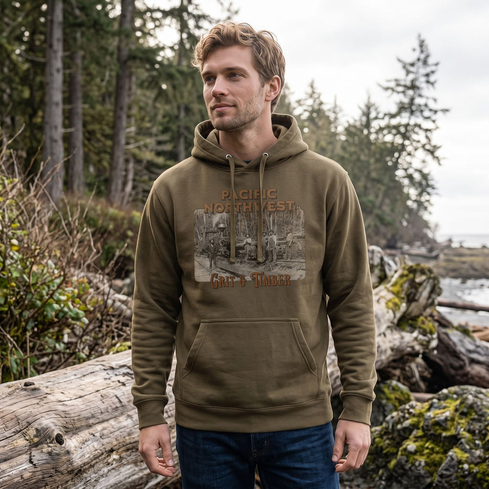Ben modeling The Grit & Timber Heavyweight Hoodie outdoors with greenery and sky, showcasing the rugged Pacific Northwest spirit.