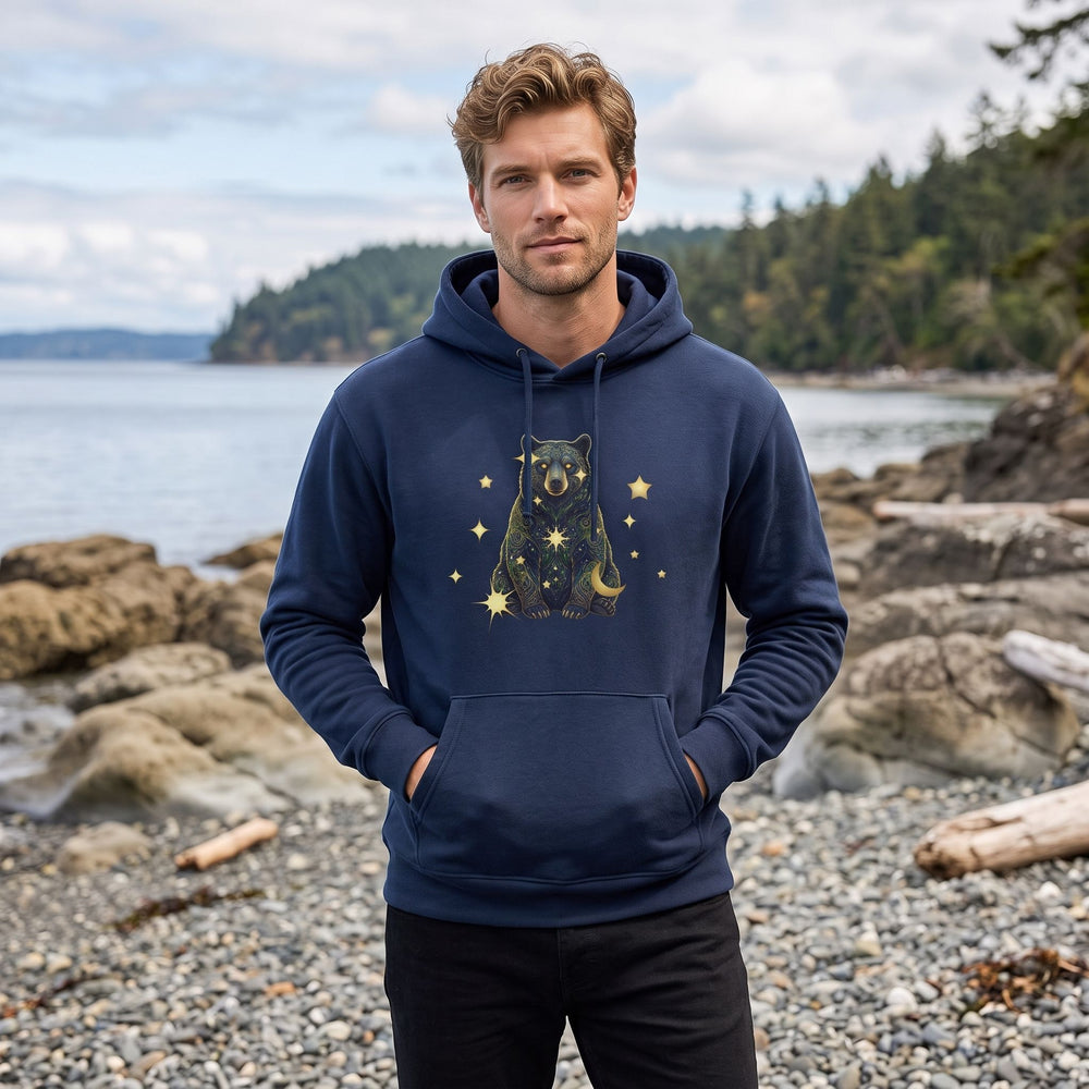 Adult model wearing Virgo Black Bear organic fleece hoodie in outdoor setting with greenery and natural daylight