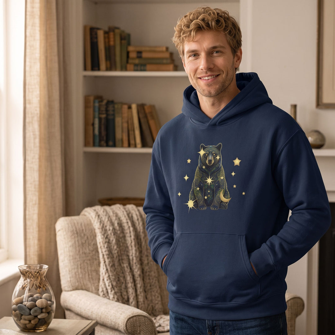 Adult male model wearing Virgo Black Bear fleece hoodie in a comfortable home environment with warm window light.